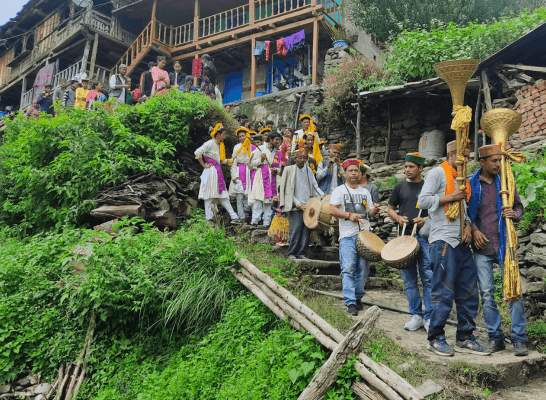 A traditional cultural procession in a rural Himalayan village